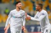 Moenchengladbach's Ramy Bensebaini, left, celebrates after scoring his side's fourth goal during the Champions League, Group B, soccer match between Shakhtar Donetsk and Borussia Moenchengladbach at the Olimpiyskiy Stadium in Kyiv, Ukraine, Tuesday, Nov. 3, 2020. (AP Photo/Efrem Lukatsky)