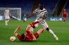 Roma's Edin Dzeko, bottom, is challenged by Manchester United's Eric Bailly during the Europa League semifinal, second leg soccer match between Roma and Manchester United at Rome's Olympic stadium, Italy, Thursday, May 6, 2021. (AP Photo/Alessandra Tarantino)