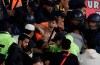 Qatari riot policemen arrest an Es Tunis fan during scuffle during the Club World Cup soccer match between AL Sadd and ES Tunis at the Khalifa International Stadium in Doha, Qatar, Tuesday, Dec. 17, 2019. (AP Photo/Hassan Ammar)