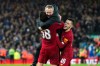 Liverpool's Under 23 coach Neil Critchley, center, celebrates with Liverpool's Pedro Chirivella and Liverpool's Adam Lewis, right, after winning the English FA Cup Fourth Round replay soccer match between Liverpool and Shrewsbury Town at Anfield Stadium, Liverpool, England, Tuesday, Feb. 4, 2020. Liverpool won 1-0. (AP Photo/Jon Super)