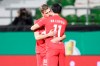 Leipzig's Hwang Hee-chan, right, celebrates with Leipzig's Daniel Olmo after scoring his side's opening goal during the German soccer cup semifinal soccer match between Werder Bremen and RB Leipzig at the Weserstadion stadium in Bremen, Germany, Friday, April 30, 2021. (Carmen Jaspersen/Pool Photo via AP)