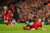 Atletico Madrid's Thomas Partey, center is tackled by Liverpool's James Milner during a second leg, round of 16, Champions League soccer match between Liverpool and Atletico Madrid at Anfield stadium in Liverpool, England, Wednesday, March 11, 2020. (AP Photo/Jon Super)