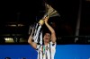 Juventus' Cristiano Ronaldo holds up the trophy as Juventus players celebrate winning an unprecedented ninth consecutive Italian Serie A soccer title, at the end of the a Serie A soccer match between Juventus and Roma, at the Allianz stadium in Turin, Italy, Saturday, Aug.1, 2020. (AP Photo/Luca Bruno)