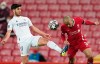 Real Madrid's Marco Asensio, left, fights for the ball with Liverpool's Fabinho during a Champions League quarter final second leg soccer match between Liverpool and Real Madrid at Anfield stadium in Liverpool, England, Wednesday, April 14, 2021. (AP Photo/Jon Super)
