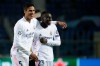 Real Madrid's Ferland Mendy, right, celebrates with Real Madrid's Raphael Varane end of the Champions League, round of 16, first leg soccer match between Atalanta and Real Madrid, at the Gewiss Stadium in Bergamo, Wednesday, Feb. 24, 2021. (AP Photo/Luca Bruno)
