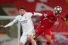 Liverpool's Thiago, right, is challenged by Real Madrid's Federico Valverde during a Champions League quarter final second leg soccer match between Liverpool and Real Madrid at Anfield stadium in Liverpool, England, Wednesday, April 14, 2021. (AP Photo/Jon Super)