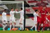 Real Madrid's Federico Valverde, left, and Real Madrid's Eder Militao celebrate celebrate at the end of the Champions League quarter final second leg soccer match between Liverpool and Real Madrid at Anfield stadium in Liverpool, England, Wednesday, April 14, 2021. (AP Photo/Jon Super)