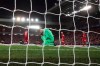 Liverpool's goalkeeper Adrian, bottom, reacts after fails to save the ball as Atletico Madrid's Marcos Llorente scores his side's second goal during a second leg, round of 16, Champions League soccer match between Liverpool and Atletico Madrid at Anfield stadium in Liverpool, England, Wednesday, March 11, 2020. (AP Photo/Jon Super)