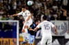 LA Galaxy forward Javier Hernandez, left, heads the ball away from Vancouver Whitecaps midfielder Russell Teibert, center, with midfielder Joe Corona, right, watching during the first half of an MLS soccer match in Carson, Calif., Saturday, March 7, 2020. (AP Photo/Alex Gallardo)