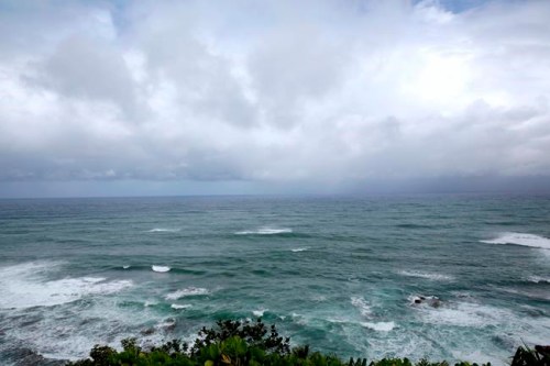 Waves crash on the shoreline at The Cliffs at Princeville resort, one of several 