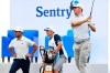 Justin Thomas follows through on a shot during the third round of the Tournament of Champions golf event as Xander Schauffele looks on, Saturday, Jan. 9, 2021, at Kapalua Plantation Course in Kapalua, Hawaii. (Matthew Thayer/The Maui News via AP)