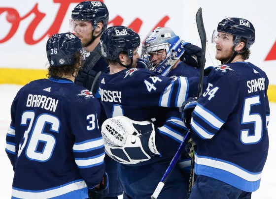 CPGoaltender Eric Comrie is congratulated by his teammates after earning his first NHL shutout in a 4-0 win over the Philadelphia Flyers on Wednesday. (John Woods / The Canadian Press)