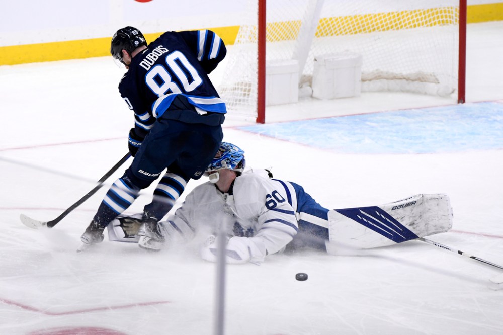 CP
Pierre-Luc Dubois collides with Toronto Maple Leafs goalie Joseph Woll during the third period Sunday. (Fred Greenslade / The Canadian Press)