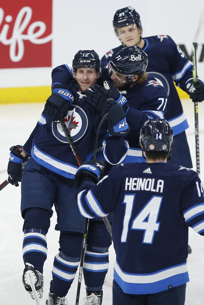CP
Jansen Harkins (12), Evgeny Svechnikov (71) and Ville Heinola (14) celebrate Harkins' early first period goal against Edmonton on Wednesday. (John Woods / The Canadian Press)