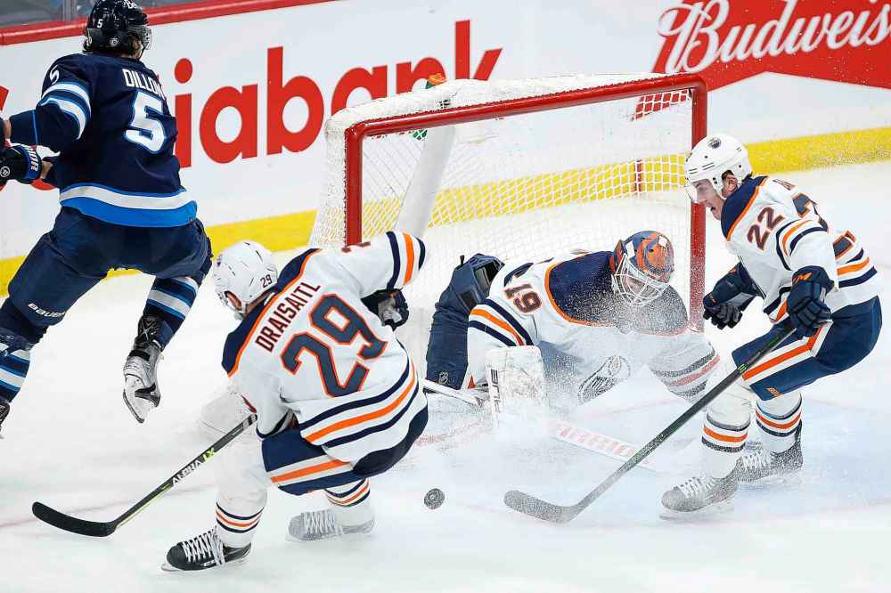 CP
Edmonton Oilers goaltender Mikko Koskinen (19) saves the shot from Winnipeg Jets' Brenden Dillon (5) as Oilers' Leon Draisaitl (29) and Tyson Barrie (22) defend during the third period. (John Woods / The Canadian Press)
