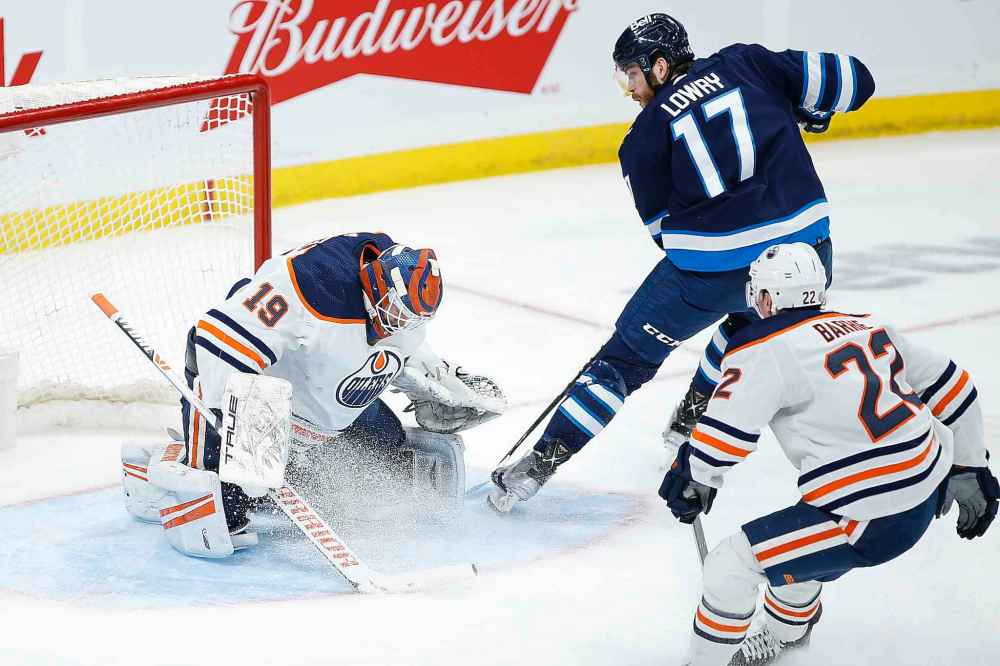 CP
Winnipeg Jets' Adam Lowry (17) shoots on Edmonton Oilers goaltender Mikko Koskinen (19) during the third period. (John Woods / The Canadian Press)