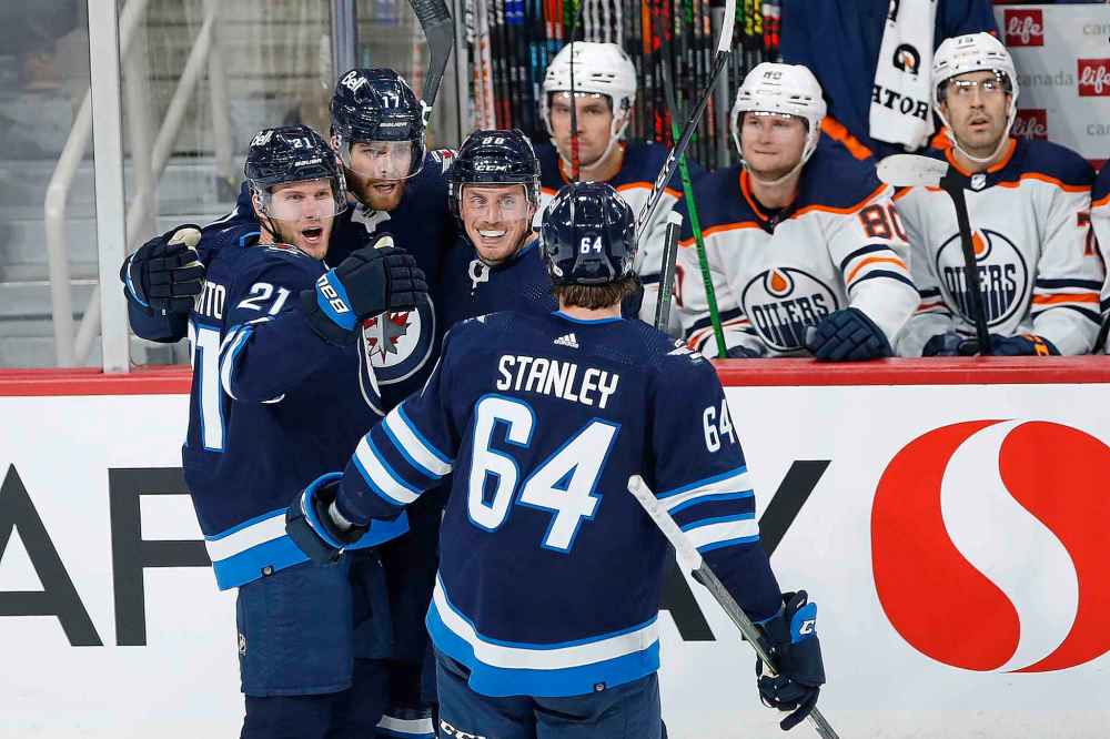 CP
Winnipeg Jets' Dominic Toninato (21), Adam Lowry (17), Nate Schmidt (88) and Logan Stanley (64) celebrate Lowry's goal against the Edmonton Oilers during the third period. (John Woods / The Canadian Press)