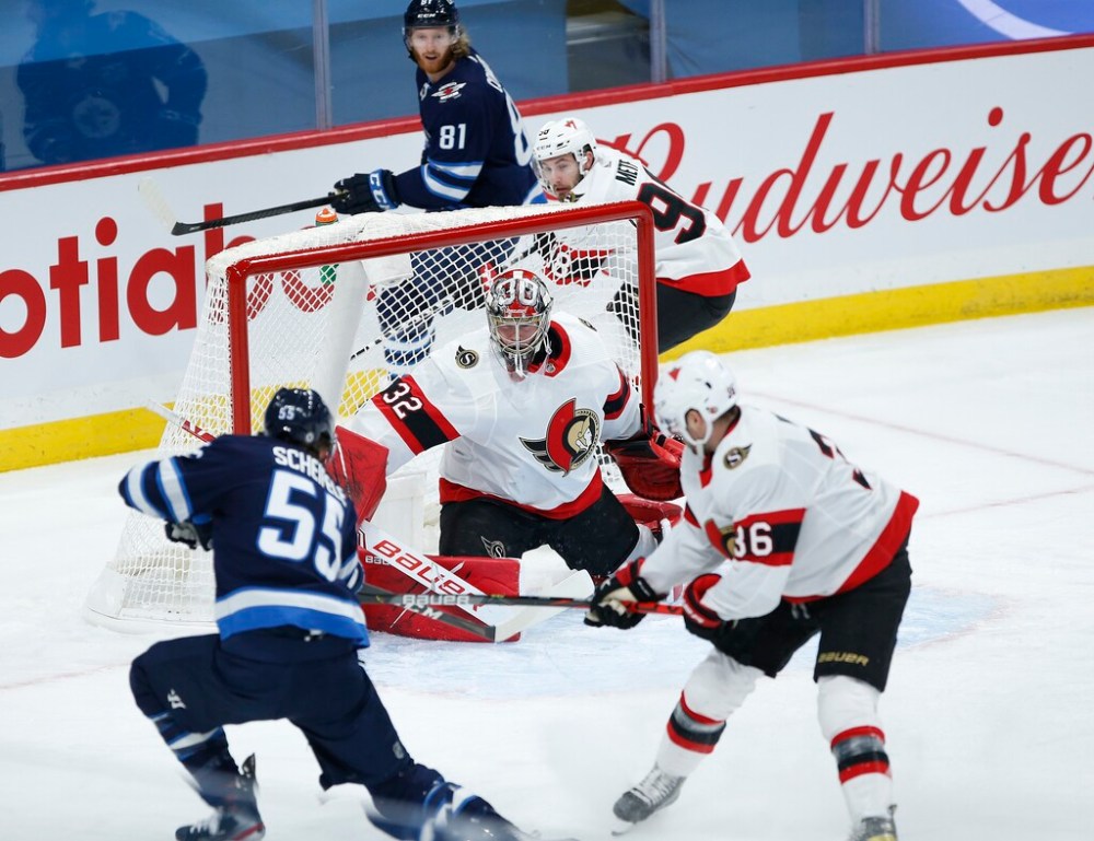 CP
Ottawa goalie Filip Gustafsson stops a shot from Mark Scheifele during the first period. (John Woods / The Canadian Press)