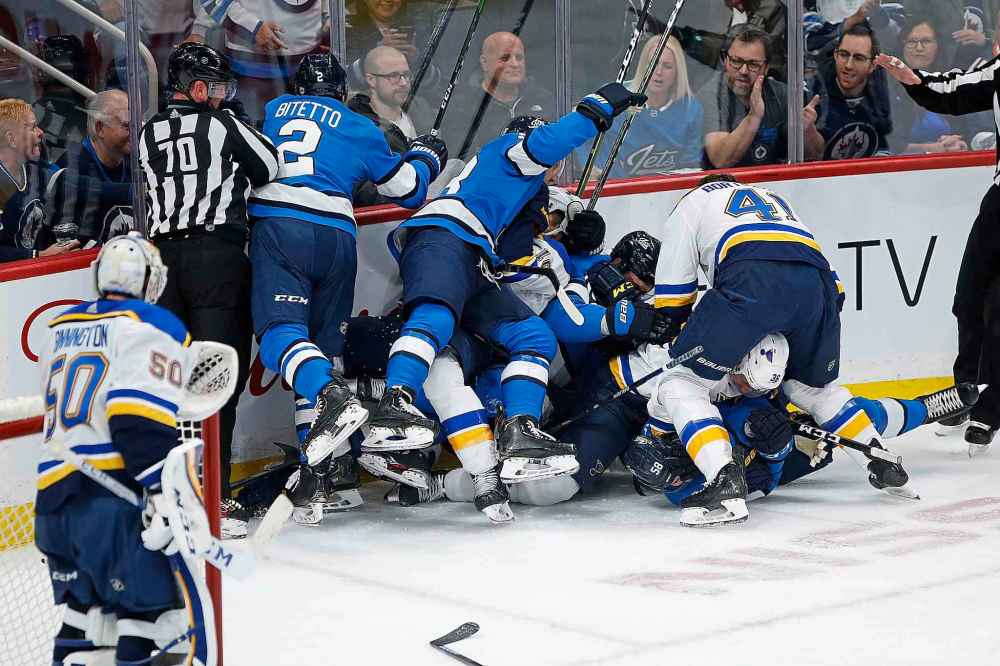 St. Louis Blues goaltender Jordan Binnington (50) looks on as the Winnipeg Jets and Blues players pile up in the corner during the first period. (John Woods / The Canadian Press)