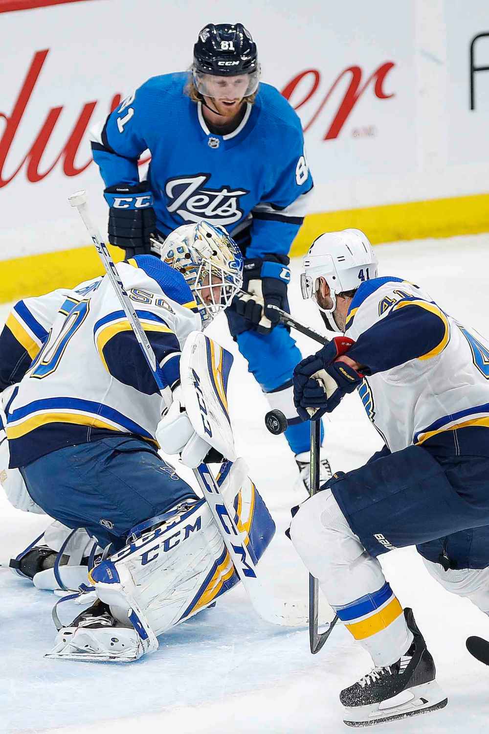 Winnipeg Jets' Kyle Connor (81) and St. Louis Blues goaltender Jordan Binnington (50) and Robert Bortuzzo (41) look for control of the loose puck during the first period. (John Woods / The Canadian Press)
