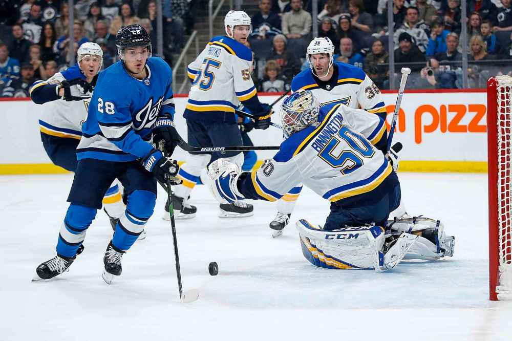 Winnipeg Jets' Jack Roslovic (28) scores on St. Louis Blues goaltender Jordan Binnington (50) during the second period. (John Woods / The Canadian Press)