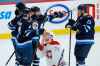 Winnipeg Jets' Neal Pionk (4), Nikolaj Ehlers (27), Mathieu Perreault (85) and Pierre-Luc Dubois (13) celebrate Ehlers' goal as Montreal Canadiens' Jake Evans (71) skates past during second period NHL action in Winnipeg on Saturday, February 27, 2021. (John Woods / The Canadian Press)