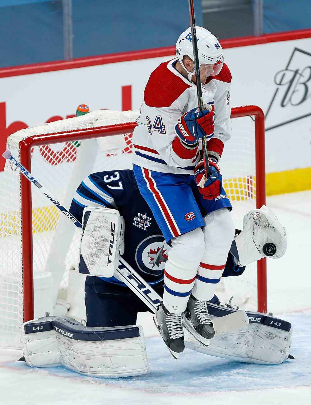 Winnipeg Jets goaltender Connor Hellebuyck (37) saves the shot as Montreal Canadiens' Corey Perry (94) screens him during the second period. (John Woods / The Canadian Press)