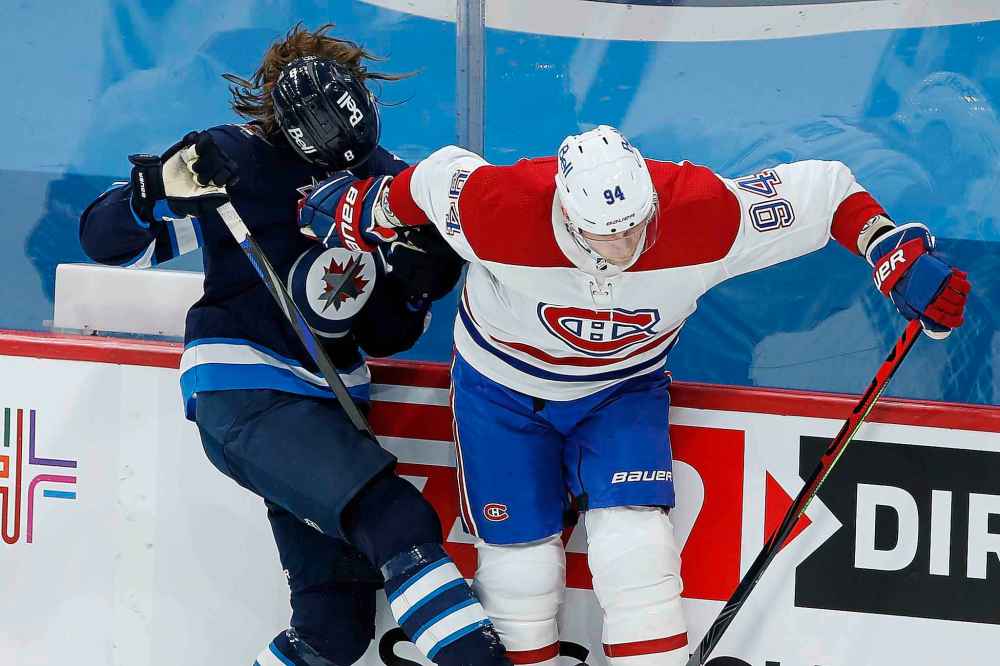 Winnipeg Jets' Sami Niku's (8) helmet flies after a collision with Montreal Canadiens' Corey Perry (94) during the first period. (John Woods / The Canadian Press)