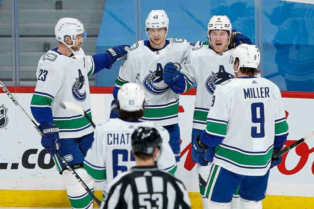 Vancouver Canucks' Alexander Edler (23), Jalen Chatfield (63), Elias Pettersson (40), Brock Boeser (6) and J.T. Miller (9) celebrate Boeser's goal against the Winnipeg Jets during the first period. (John Woods / The Canadian Press)