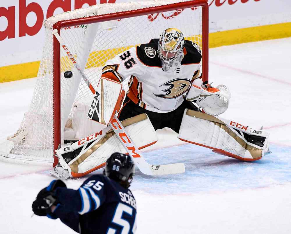 Winnipeg Jets' Mark Scheifele (55) scores on Anaheim Ducks goaltender John Gibson (36) during the first period. (Fred Greenslade / The Canadian Press)