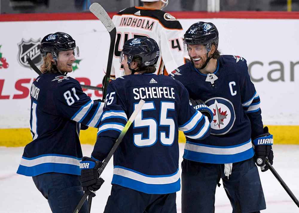 Winnipeg Jets' Mark Scheifele (55) celebrates his game-winning goal against the Anaheim Ducks with Kyle Connor (81) and Blake Wheeler (26) during the third period. (Fred Greenslade / The Canadian Press)