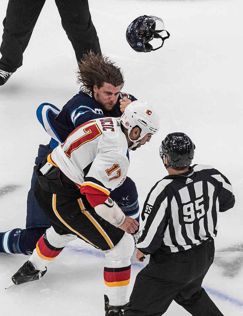 Calgary Flames' Milan Lucic (17) fights Winnipeg Jets' Nathan Beaulieu (88) during first period NHL qualifying round game action in Edmonton, on Thursday August 6, 2020. (Jason Franson / The Canadian Press)