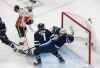 Calgary Flames' Sam Bennett (93) scores a goal on Winnipeg Jets goalie Connor Hellebuyck (37) as Jets Dmitry Kulikov (7) defends during first period NHL qualifying round game action in Edmonton, on Thursday August 6, 2020. (Jason Franson / The Canadian Press)