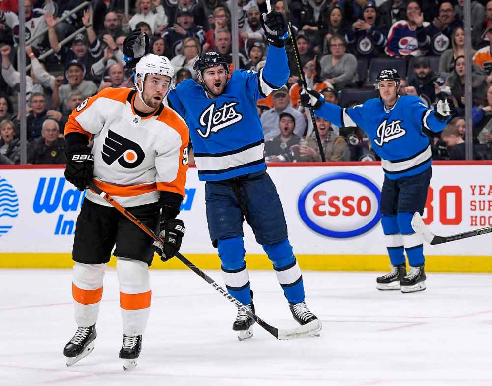 FRED GREENSLADE / THE CANADIAN PRESS
Winnipeg Jets' Logan Shaw (38) celebrates his goal as Philadelphia Flyers' Ivan Provorov (9) looks on during second period NHL action in Winnipeg on Sunday Dec. 15, 2019.