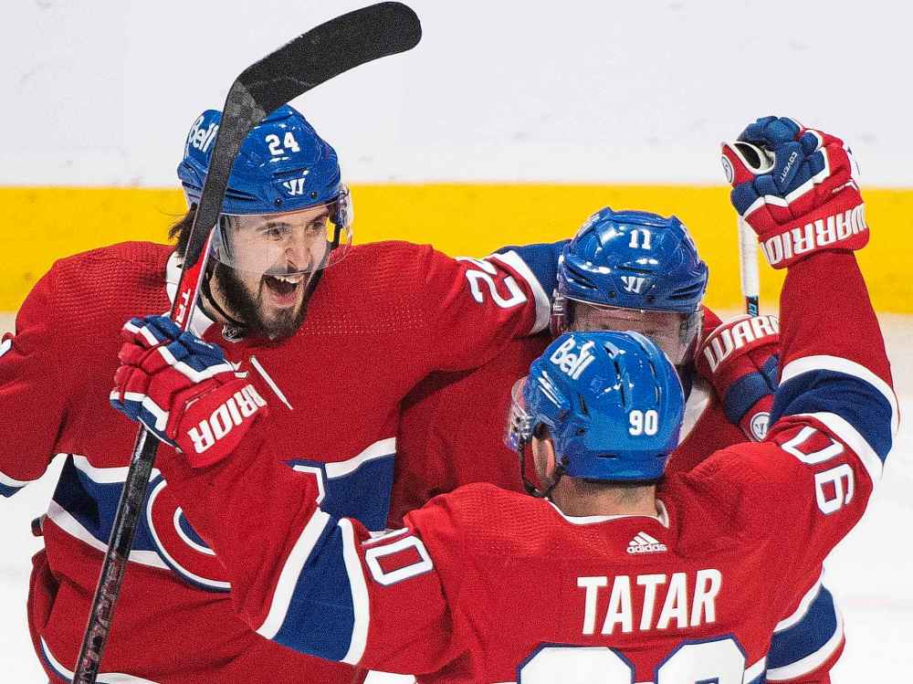 Montreal Canadiens’ Brendan Gallagher (11) celebrates with teammates Phillip Danault (24) and Tomas Tatar (90) after scoring against the Winnipeg Jets during second period NHL hockey action in Montreal, Saturday, March 6, 2021. (Graham Hughes / The Canadian Press)