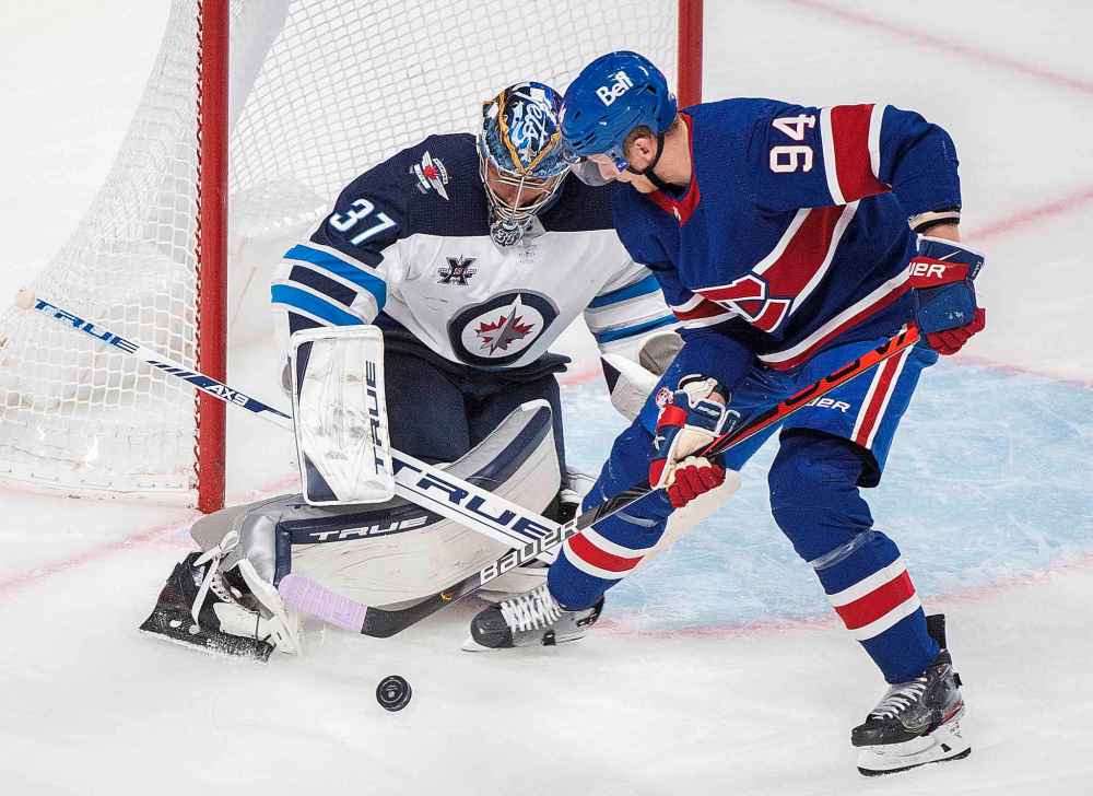 CP
Montreal Canadiens' Corey Perry moves in on Winnipeg Jets goaltender Connor Hellebuyck during the first period. (Graham Hughes / The Canadian Press)