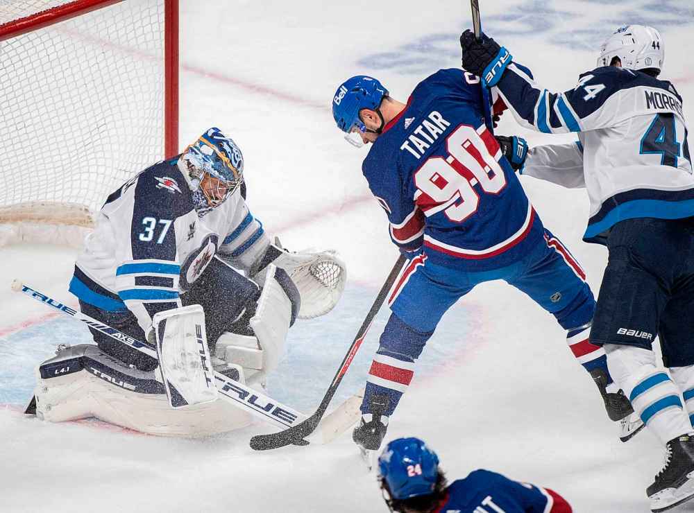 CP
Montreal Canadiens' Tomas Tatar (90) moves in on Winnipeg Jets goaltender Connor Hellebuyck as Jets' Josh Morrissey defends during the third period. (Graham Hughes / The Canadian Press)