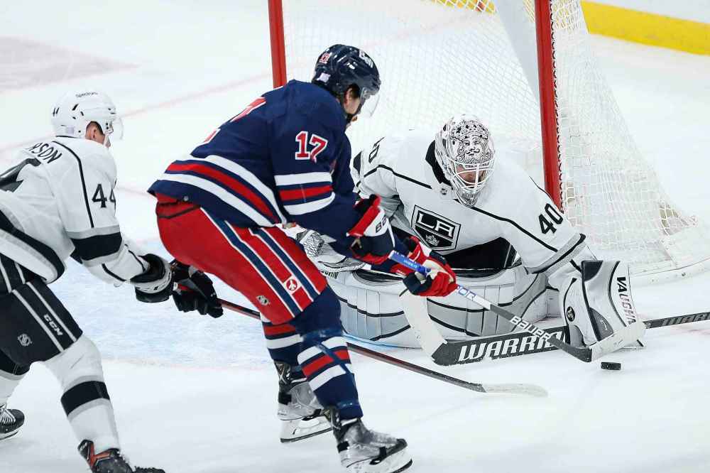 CP
Los Angeles Kings goaltender Cal Petersen (40) pokes the puck away from Winnipeg Jets' Adam Lowry (17) as Mikey Anderson (44) defends during the second period. (John Woods / The Canadian Press)