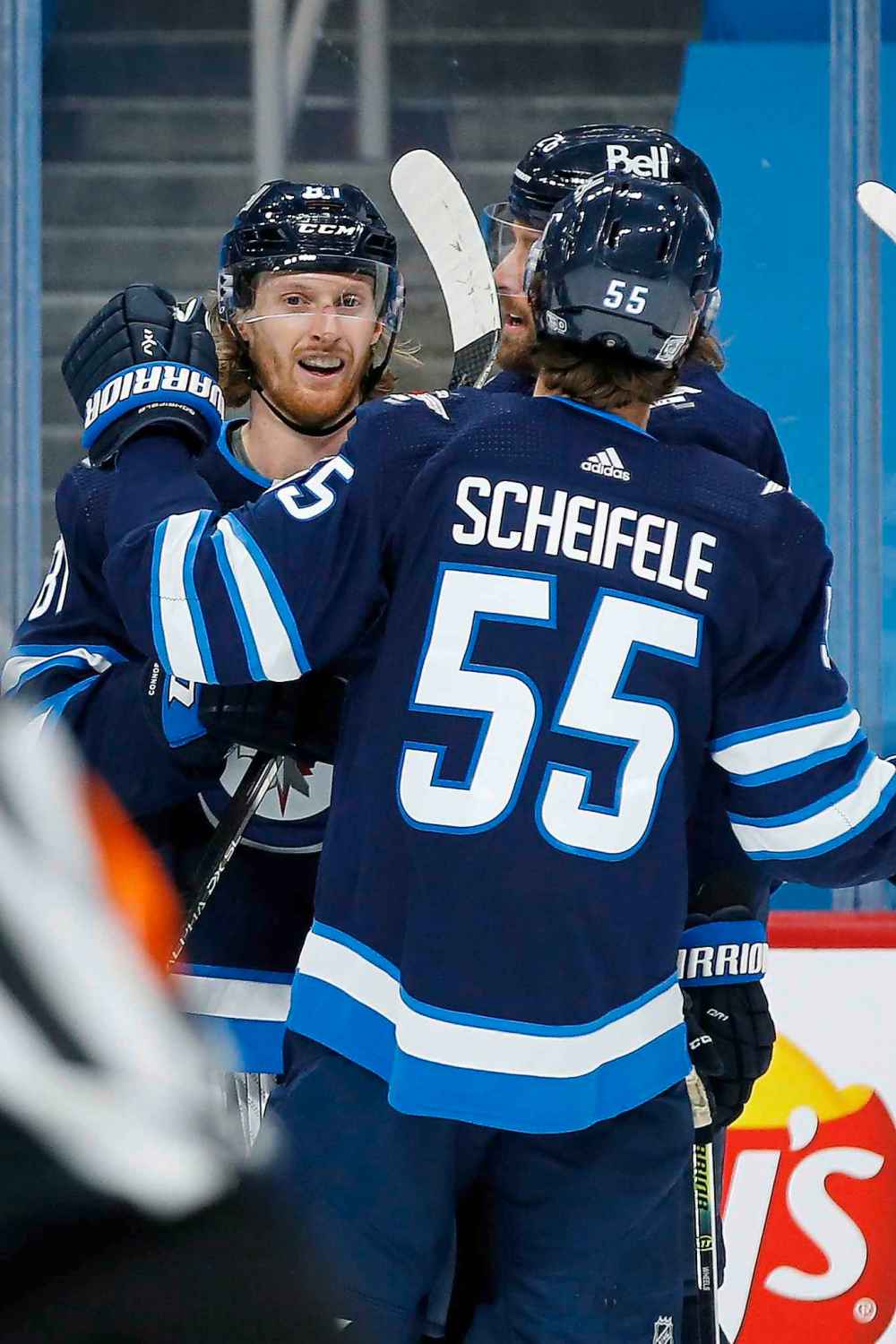 Winnipeg Jets' Mark Scheifele (55), Blake Wheeler (26) and Kyle Connor (81) celebrate Connor's goal against the Ottawa Senators during second period NHL action in Winnipeg on Saturday, January 23, 2021. (John Woods / The Canadian Press)