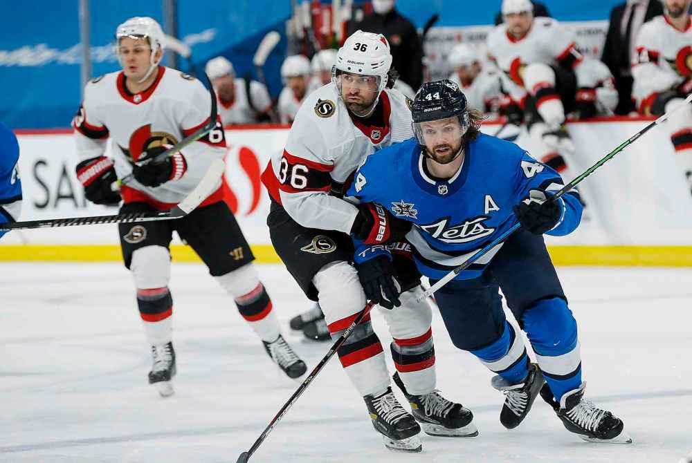 Winnipeg Jets' Josh Morrissey (44) and Ottawa Senators' Colin White (36) jockey for position during the second period. (John Woods / The Canadian Press)