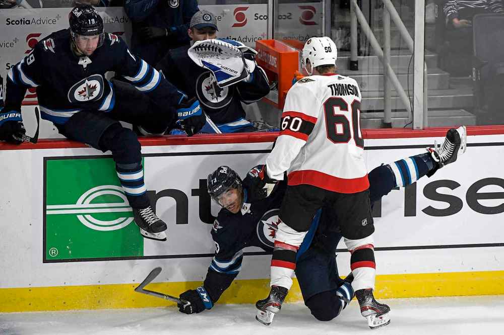 CP
Winnipeg Jets' CJ Suess (73) is checked by Ottawa Senators’ Lassi Thomson (60) during the second period. (Fred Greenslade / The Canadian Press)