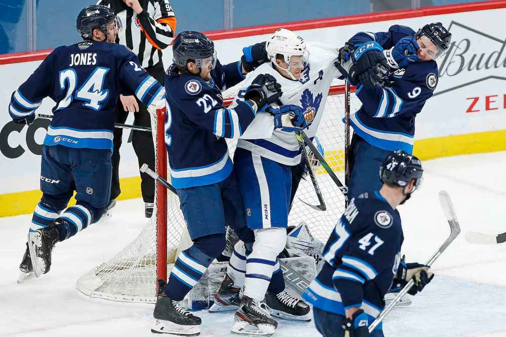 JOHN WOODS / WINNIPEG FREE PRESS
JOHN WOODS / WINNIPEG FREE PRESS
Manitoba Moose Joona Luoto (22) and Leon Gawanke (9) mix it up with Toronto Marlies’ Tyler Gaudet (58) in front of Moose goaltender Mikhail Berdin at Bell MTS Place Tuesday.