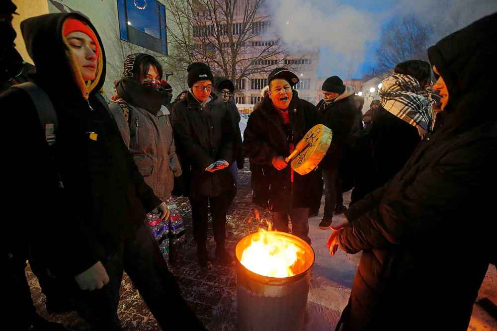 JOHN WOODS / WINNIPEG FREE PRESS
People gather for a protest against the removal of tents from a homeless encampment on in front of Winnipeg City Hall Thursday evening.