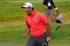 Jon Rahm reacts after making his putt on the first playoff hole during the final round of the BMW Championship golf tournament at the Olympia Fields Country Club in Olympia Fields, Ill., Sunday, Aug. 30, 2020. (AP Photo/Charles Rex Arbogast)