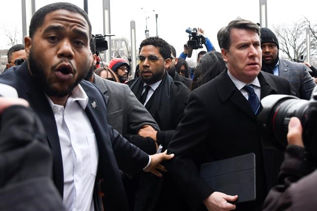 Actor Jussie Smollett, center, arrives for a court appearance at the Leighton Criminal Courthouse in Chicago, Monday Feb. 24, 2020, on a new set of charges alleging that he lied to police about being targeted in a racist and homophobic attack in downtown Chicago early last year. (AP Photo/Matt Marton)