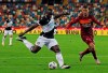 Udinese player Stefano Okaka kicks the ball during the Serie A soccer match between Udinese and Roma, at the Dacia Arena in Udine, Italy, Saturday, Oct. 3, 2020. (Andrea Bressanutti/LaPresse via AP)