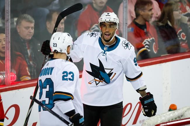 San Jose Sharks' Evander Kane, right, celebrates his goal with teammate Barclay Goodrow during second period NHL hockey action against the Calgary Flames in Calgary on February 4, 2020. A group advocating for diversity in hockey is calling for the NHL to suspend Thursday's playoff games in the aftermath of a police shooting of Jacob Blake, a Black man, in Wisconsin last weekend. San Jose Sharks winger Evander Kane says the Hockey Diversity Alliance has formally requested the NHL suspend a pair of post-season games scheduled for Toronto and Edmonton. THE CANADIAN PRESS/Jeff McIntosh