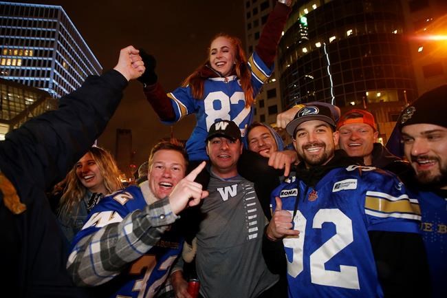 Winnipeg Blue Bomber fans celebrate winning the 107th Grey Cup over the Hamilton Tiger Cats at the intersection of Portage and Main in Winnipeg on November 24, 2019. Mike Goodchild had a lot more time for vacation and house projects this summer but the Winnipeg Blue Bombers fan was holding out hope his schedule would fill up with football games soon, even if it was a shortened season. He's not particularly surprised the season was scrapped Monday but disappointed his team won't be able to defend their Grey Cup championship.