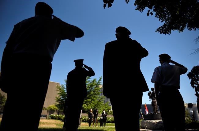 Korean War veterans along with Lt.Gen. Wayne Eyre, Commander of the Canadian Army, salute, second from left, during a ceremony commemorating the 70th anniversary of the Korean War at the Monument to the Canadian Fallen in Ottawa, on Sunday, June 21, 2020. THE CANADIAN PRESS/Justin Tang