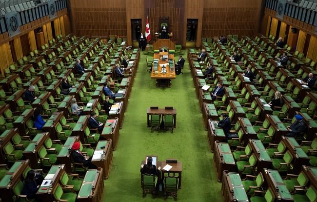 Members of Parliament, attending in limited numbers and seated apart to practice physical distancing, wait for proceedings to begin in the House of Commons on Parliament Hill in Ottawa, as Parliament was recalled for the consideration of measures related to the COVID-19 pandemic, on Saturday, April 11, 2020. THE CANADIAN PRESS/Justin Tang